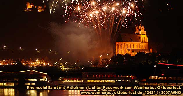 Firework display round boat trip Rhine river lights r in October with DJ music and dance on board, golden wine autumn and swimming October festival on the Middle Rhine River in Germany.